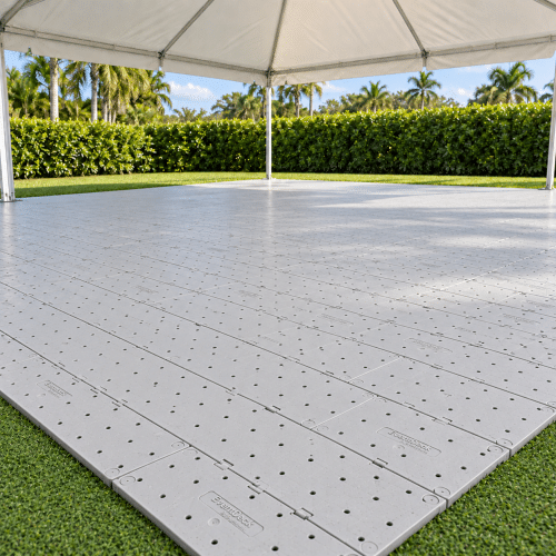 Light gray EventDeck modular flooring installed beneath a white frame tent